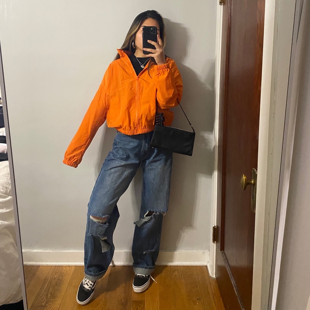 Orange jacket with hidden hood in collar
